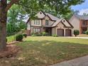 Charming home with a well-manicured lawn and a two-car garage, complemented by lush landscaping at 3943 Dunaire Dr, Stone Mountain, GA 30083