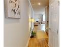 Hallway entrance leading to living room, with hardwood floors, and a plant at 532 Walton Dr, Woodstock, GA 30188
