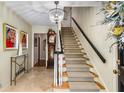 Inviting foyer with staircase, chandelier, and decorative details creating a warm and elegant entrance at 4716 N Springs Ct, Atlanta, GA 30338