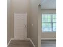 Bright entryway featuring wood-look floors, white door, and abundant natural light at 589 Arbor Ridge Dr, Stone Mountain, GA 30087