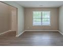 Inviting living room with wood-look floors and a large window at 589 Arbor Ridge Dr, Stone Mountain, GA 30087