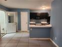 Open concept kitchen with black cabinets, a breakfast bar and tile flooring at 5574 Fair Creek Way, Lithonia, GA 30038