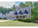 Charming home with a covered porch, complemented by an expansive, well-maintained lawn and an attached two-car garage at 900 Meadowsong Cir, Lawrenceville, GA 30043
