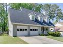 Charming home with a welcoming porch, complemented by a well-maintained lawn and an attached two-car garage at 900 Meadowsong Cir, Lawrenceville, GA 30043