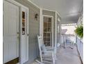 Inviting front porch featuring rocking chairs, decorative pillows, and views of the surrounding landscape at 900 Meadowsong Cir, Lawrenceville, GA 30043