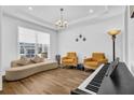 Bright living room featuring hardwood floors, a piano, and modern décor, perfect for entertaining at 307 Ernest Ave, Peachtree City, GA 30269