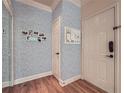 Stylish foyer with wood floors, decorative wall paper and organized bulletin board at 3777 Peachtree Ne Rd # 1512, Brookhaven, GA 30319