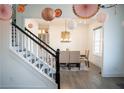 Elegant dining room adjacent to staircase with modern chandelier and decor at 3790 Andover St, Cumming, GA 30028