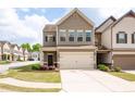 Charming two-story townhome featuring a two-car garage and manicured front lawn with a cozy entrance at 406 Crescent Woode Dr, Dallas, GA 30157