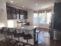 Modern kitchen featuring granite countertops, stainless steel appliances, and breakfast bar at 10650 Allon Cv # 137, Alpharetta, GA 30022