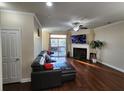 Cozy living room with hardwood floors, fireplace, and access to outdoor deck at 10650 Allon Cv # 137, Alpharetta, GA 30022