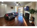 Cozy living room with hardwood floors, fireplace, and access to outdoor deck at 10650 Allon Cv # 137, Alpharetta, GA 30022