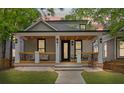 Charming home boasts a welcoming porch, manicured lawn, and craftsman details at 293 Ormond Se St, Atlanta, GA 30315