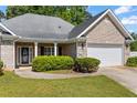 The front exterior offers a quaint columned porch and a two-car garage providing both charm and convenience at 4368 Magnolia Bay Ln, Snellville, GA 30039
