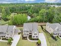 An aerial view of a beautifully landscaped home with a private backyard overlooking a serene pond at 5075 Briarstone Ridge Way, Alpharetta, GA 30022