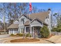 Attractive two-story home with a manicured front yard, inviting entrance, and an American flag at 2109 Rugby Ave, Atlanta, GA 30337