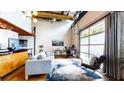 Contemporary living space with high ceilings, exposed beams, and large windows with garage style door at 1661 La France Ne St # 221, Atlanta, GA 30307