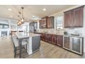 Modern kitchen with dark cabinets, stainless steel appliances, granite countertops, and an island with bar stool seating at 197 Hickory Pointe Dr, Acworth, GA 30101