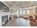 Comfortable living room with a fireplace, coffered ceiling, large sectional sofa, and wood-look floors at 197 Hickory Pointe Dr, Acworth, GA 30101