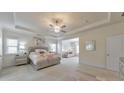 Spacious primary bedroom with tray ceilings, ceiling fan, ensuite seating area, and neutral decor at 197 Hickory Pointe Dr, Acworth, GA 30101