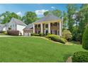 Beautiful landscaped lawn with a stately brick home featuring a three-car garage at 320 Rossiter Rdg, Alpharetta, GA 30022