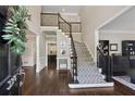 Inviting foyer with hardwood floors and staircase with decorative carpet runner at 320 Rossiter Rdg, Alpharetta, GA 30022