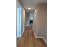 Hallway features wood-look flooring and leads to the living area with a fireplace at 1356 Ambercrest Way, Austell, GA 30168