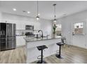 Modern kitchen with stainless steel appliances, granite countertops, and pendant lighting over the breakfast bar at 1386 Ben Park Way, Grayson, GA 30017
