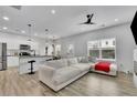Bright, modern living room featuring a large sectional sofa, hardwood floors and lots of natural light at 1386 Ben Park Way, Grayson, GA 30017