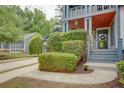 Well-manicured landscaping frames this home with a covered porch and a detached garage in the background at 2604 Porchside Se Pl, Atlanta, GA 30316