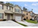 Beautiful townhouse with stone accents, a garage, and well-maintained landscaping at 4370 Stone Gate Way # 97, Atlanta, GA 30344