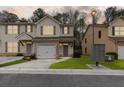 Inviting townhouse showcasing neutral siding, decorative shutters, and a manicured lawn at 4370 Stone Gate Way # 97, Atlanta, GA 30344