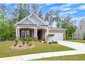 Attractive home featuring a brick facade, dormer windows, and lush green landscaping at 448 Marston Pass, Acworth, GA 30102