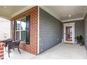 Cozy front porch featuring brick columns, wicker chairs, and a view of the entrance at 448 Marston Pass, Acworth, GA 30102