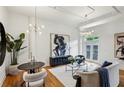 Bright living room featuring hardwood floors, modern lighting, stylish furniture, and abstract art at 1058 Piedmont Ave # 103, Atlanta, GA 30309