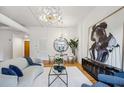 Living room with hardwood floors, abstract art, modern lighting and partial view of the modern kitchen at 1058 Piedmont Ave # 103, Atlanta, GA 30309