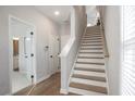 Hallway boasts hardwood floors, staircase, and access to a bathroom at 1895 Deco Dr, Kennesaw, GA 30144