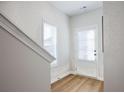 Hallway features hardwood floors and a door with natural light at 1895 Deco Dr, Kennesaw, GA 30144