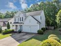 Two-story home with well-manicured lawn, two-car garage, and lovely front porch at 338 Santa Anita Ave, Woodstock, GA 30189