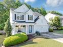 Charming two-story home with manicured lawn and a cozy front porch with flowers at 338 Santa Anita Ave, Woodstock, GA 30189