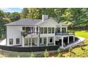 Expansive backyard featuring multiple decks, a covered patio, and a lush green yard at 507 Karen Ln, Woodstock, GA 30188