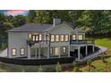 Expansive backyard featuring multiple decks, a covered patio, and a lush green yard at 507 Karen Ln, Woodstock, GA 30188