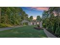 Charming one-story home featuring a side entry garage, stone accents, and lush landscaping at 507 Karen Ln, Woodstock, GA 30188