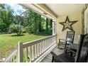 Cozy front porch with rocking chairs, offering a relaxing outdoor space with views of the green lawn at 83 Andrew Jackson Ct, Dallas, GA 30157