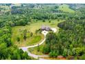 A high angle view showcases the estate's layout, surrounded by lush trees, landscaping, and a winding driveway at 1101 N Flat Rock Rd, Douglasville, GA 30134