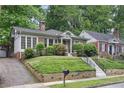 Charming brick home with beautiful landscaping, well-manicured lawn and inviting walkway at 203 Lucerne St, Decatur, GA 30030