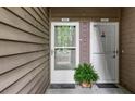 Dual entrance to units with a cozy welcome mat and fresh plant, exemplifying the inviting atmosphere at 605 Parkaire Xing, Marietta, GA 30068