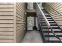 Condo entrance with exterior staircase leading to upper-level units, showcasing the building's layout and design at 605 Parkaire Xing, Marietta, GA 30068