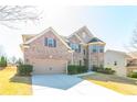 Beautiful two-story brick home with an attached garage and a neatly landscaped front yard at 335 Roberts Run Cv, Suwanee, GA 30024