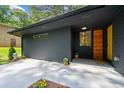 A freshly painted house with a mix of brick and plank siding with a wooden door at 3964 Gretna Green Dr, Decatur, GA 30035